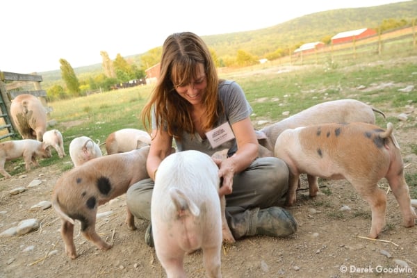 Susie Coston with piglets at Farm Sanctuary