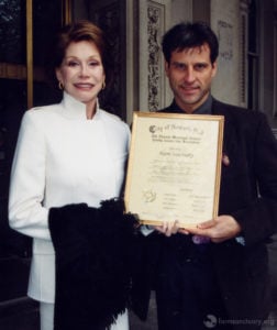 Mary Tyler Moore and Gene Baur hold a resolution from the City of Newark, NJ.